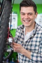 Portrait Of Male Small Business Owner Repairing Gears In Bicycle Repair Shop