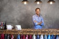 Portrait Of Male Store Owner Standing Behind Cash Desk Royalty Free Stock Photo