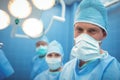 Portrait of male surgeon wearing surgical mask in operation theater Royalty Free Stock Photo