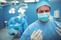 Portrait of male surgeon wearing surgical mask in operation theater Royalty Free Stock Photo