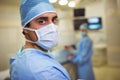 Portrait of male surgeon wearing surgical mask in operation theater Royalty Free Stock Photo