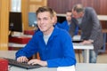 Portrait male teenager in blue jacket using computer Royalty Free Stock Photo