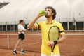 Portrait of tennis player standing in court with a racquet in his hands Royalty Free Stock Photo