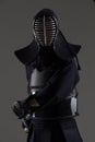 Portrait of male in tradition kendo armor with bamboo sword
