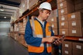 Portrait of a male warehouse supervisor in white hardhat using digital tablet in factory Royalty Free Stock Photo