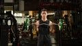 A portrait of a male weightlifter in black sportswear. He does barbell fitness workout in the modern gym Royalty Free Stock Photo