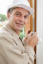 portrait male worker fitting handle on window Royalty Free Stock Photo