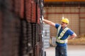 Portrait of a male worker wearing a safety vest and helmet standing on a steels pallet due to back pain from working Royalty Free Stock Photo