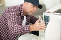 Portrait man adjusting air conditioning system