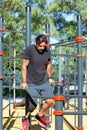 Portrait of man with artificial leg practicing on bars in summer