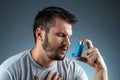 Portrait of a man with an asthma inhaler in his hands, an asthmatic attack. The concept of treatment of bronchial asthma, cough, Royalty Free Stock Photo