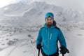 Portrait of man backcountry skier hiking to the summit of a snowy peak in the Low Tatras in Slovakia.