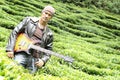 Portrait of a man with bass guitar in the nature