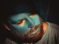 Portrait of a man with a blue make-up on his face. Stage make-up, like an alien, fantasy. Royalty Free Stock Photo