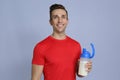 Portrait of man with bottle of protein shake