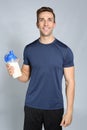 Portrait of man with bottle of protein shake