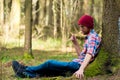 Portrait of a man in a cap and plaid shirt sitting Royalty Free Stock Photo