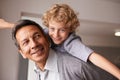 Portrait, man and child with piggyback for multiracial family, bonding and together at home. Happy, retired male person