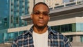 Portrait of man in city african american guy young student man in stylish sunglasses wears plaid shirt looks posing