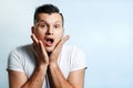 Portrait of a man close-up, who is surprised to spread his hands. On a light background. The concept of human emotions Royalty Free Stock Photo