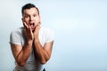 Portrait of a man close-up, who is surprised to spread his hands. On a light background. The concept of human emotions Royalty Free Stock Photo