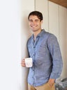 Portrait, man and coffee for casual, fashion and aesthetic in stylish outfit in home on weekend. Male entrepreneur Royalty Free Stock Photo