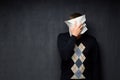 Portrait of man covering his face with paper sheet Royalty Free Stock Photo