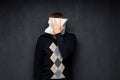 Portrait of man covering his face with paper sheet Royalty Free Stock Photo