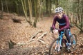 Portrait of man cross-country cycling in a forest, close up Royalty Free Stock Photo