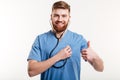 Portrait of man doctor with stethoscope showing thumb up. Royalty Free Stock Photo