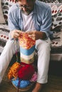 Portrait of man doing female style hobby leisure activity at home busy in knitting wool work. Anti no stress activity for people. Royalty Free Stock Photo