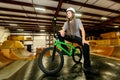 Portrait of a man with dredlocks and a helmet on a BMX bike