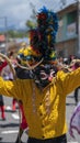 Portrait of man dressed as a black and yellow devil parading in the Diablada Pillarena in the city of Pillaro - Ecuador