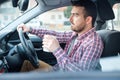 Man drinking coffee while driving the car Royalty Free Stock Photo