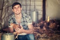 Portrait of man farmer with chicken on poultry farm indoors Royalty Free Stock Photo