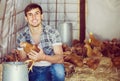 Portrait of man farmer with chicken on poultry farm indoors Royalty Free Stock Photo