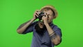 Portrait of man tourist photographer is taking photos on camera. Chroma key
