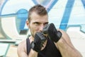 Portrait of man fighter in boxing pose, urban style.