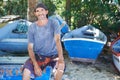 Portrait, man and fisherman on boat by beach outdoor in summer or smoking cigarette in nature. Fishing, mature person