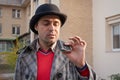 Portrait of a man with a flask in his hands outdoors on a sunny day. Alcoholism concept, combating alcohol addiction