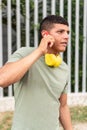 man with freckles, enjoying a cell phone conversation while standing in the city park Royalty Free Stock Photo