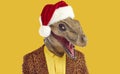 Man in funny dinosaur mask, red Christmas hat and leopard jacket isolated on yellow background