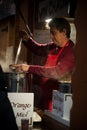 Portrait of man giving a cup of mulled wine at the christmas market