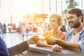 Portrait of man giving passport to passenger service agent to get his boarding pass in airport Royalty Free Stock Photo