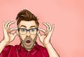 Portrait of man in glasses says wow with open mouth to see something unexpected. Royalty Free Stock Photo