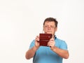 Portrait of a man in glasses on a white background with a phone Royalty Free Stock Photo