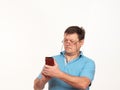 Portrait of a man in glasses on a white background with a phone Royalty Free Stock Photo