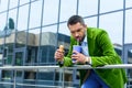 portrait of man in green velvet jacket with french hot dog drinking soda drink Royalty Free Stock Photo