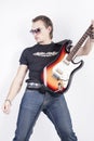 Portrait of Man With Guitar Posing Expressively Against White Background.