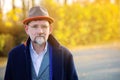 Portrait of man in his 50s in blue suit and coat outdoors Royalty Free Stock Photo